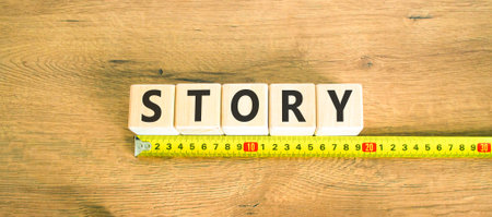 Story symbol. Concept word Story on beautiful wooden blocks. Beautiful wooden table wooden background. Beautiful yellow ruler. Business lifestyle story concept. Copy space.の写真素材