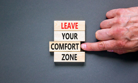 Leave your comfort zone symbol. Concept words Leave your comfort zone on beautiful wooden blocks. Beautiful gray paper background. Business psychological Leave your comfort zone concept. Copy space.の写真素材