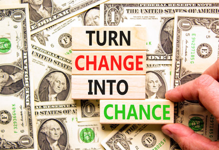 Turn change into chance symbol. Concept words phrase Turn change into chance on beautiful blocks. Dollar bills. Beautiful dollar bills background. Business Turn change into chance concept. Copy space.の写真素材