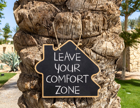 Leave your comfort zone symbol. Concept words Leave your comfort zone on beautiful black blackboard. Beautiful old tree background. Business psychological Leave your comfort zone concept. Copy space.の写真素材