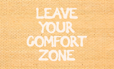 Leave your comfort zone symbol. Concept words Leave your comfort zone on beautiful brick wall. Beautiful brown brick wall background. Business psychological Leave your comfort zone concept. Copy spaceの写真素材