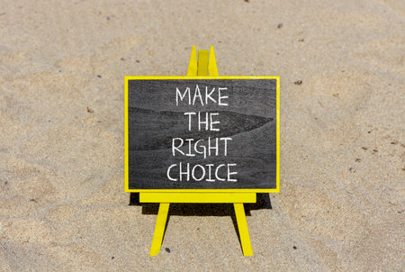 Make the right choice symbol. Concept words phrase Make the right choice on beautiful black blackboard. Beautiful sand beach background. Business Make the right choice concept. Copy space.の写真素材