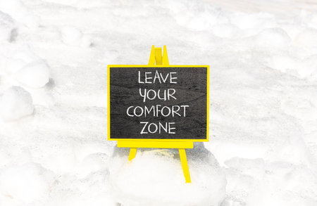 Leave your comfort zone symbol. Concept words Leave your comfort zone on beautiful black blackboard. Beautiful white snow background. Business psychological Leave your comfort zone concept. Copy spaceの写真素材