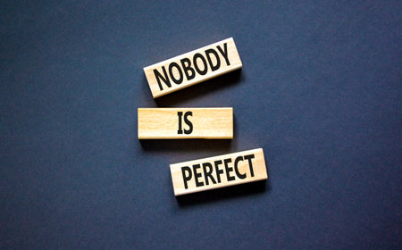 Nobody is perfect symbol. Concept words Nobody is perfect on beautiful wooden block. Beautiful black table black background. Business motivational lifestyle and nobody is perfect concept. Copy space.の写真素材