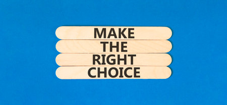 Make the right choice symbol. Concept words phrase Make the right choice on beautiful wooden stick. Beautiful blue paper background. Business Make the right choice concept. Copy space.の写真素材