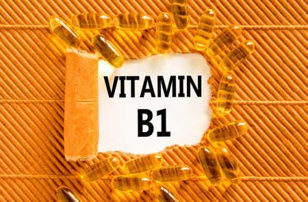 Vitamin B1 symbol. Concept words Vitamin B1 on beautiful white paper. Yellow pills tablets. Beautiful brown background. Medical healthy lifestyle Vitamin B1 concept.の写真素材
