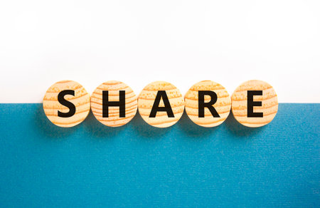 Share symbol. Concept word Share on beautiful wooden circles. Beautiful white and blue background. Business lifestyle share concept. Copy space.の写真素材