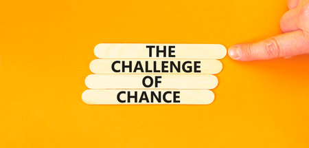 The challenge of chance symbol. Concept words phrase The challenge of chance on beautiful wooden stick. Beautiful orange paper background. Business The challenge of chance concept. Copy space.の写真素材