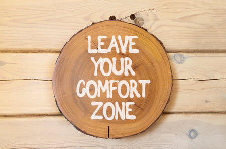Leave your comfort zone symbol. Concept words Leave your comfort zone on beautiful wooden circle....