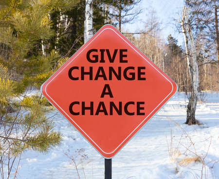 Give change a chance symbol. Concept words phrase Give change a chance on beautiful red road sign. Beautiful winter forest background. Business Give change a chance concept. Copy space.の写真素材