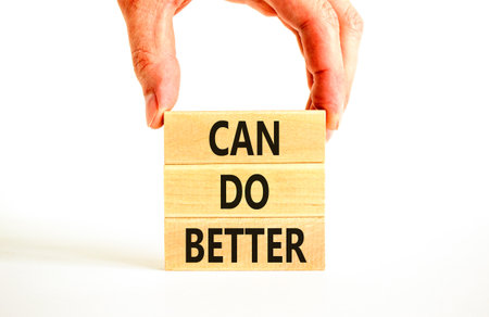 Can do better symbol. Concept words Can do better on beautiful wooden block. Businessman's hand....