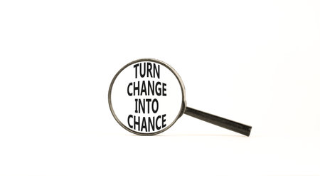 Turn change into chance symbol. Concept words phrase Turn change into chance in beautiful black magnifying glass. Beautiful white background. Business Turn change into chance concept. Copy space.の写真素材