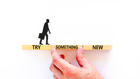 Try something new symbol. Concept words Try something new on beautiful block. Businessman's hand. Beautiful white background. Business motivational lifestyle try something new concept. Copy space.の写真素材