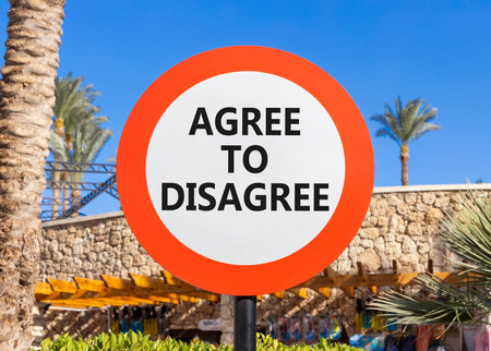 Agree to disagree symbol. Concept words Agree to disagree on beautiful big white road sign. Beautiful palm tree hotel blue sky background. Business and agree to disagree concept. Copy space.の写真素材