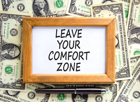 Leave your comfort zone symbol. Concept words Leave your comfort zone on beautiful picture frame. Beautiful dollar bills background. Business psychological Leave your comfort zone concept. Copy space.の写真素材