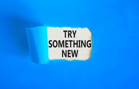 Try something new symbol. Concept words Try something new on beautiful white paper. Beautiful blue paper background. Business motivational lifestyle try something new concept. Copy space.の写真素材