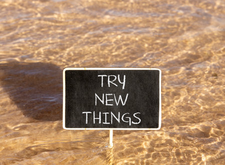 Try new things symbol. Concept words Try new things on beautiful blackboard. Beautiful Red sea water background. Business motivational lifestyle try new things concept. Copy space.の写真素材