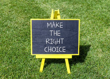 Make the right choice symbol. Concept words phrase Make the right choice on beautiful black blackboard. Beautiful green grass lawn background. Business Make the right choice concept. Copy space.の写真素材