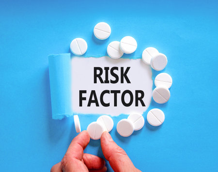 Risk factor symbol. Concept words Risk factor on beautiful white paper. White pills tablets. Doctor's hand. Beautiful blue background. Medical healthy lifestyle risk factor concept.の写真素材