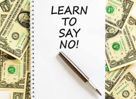 Learn to say no symbol. Concept words phrase Learn to say no on beautiful white note. Dollar bills. Beautiful dollar bills background. Business psychological Learn to say no concept. Copy space.の写真素材