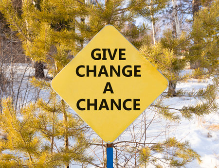 Give change a chance symbol. Concept words phrase Give change a chance on beautiful yellow road sign. Beautiful winter forest background. Business Give change a chance concept. Copy space.の写真素材