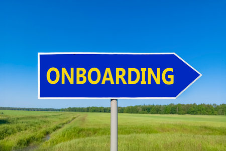 Onboarding success symbol. Concept word Onboarding on beautiful blue road sign. Beautiful blue sky green grass and forest peaceful nature background. Business onboarding success concept. Copy space.の写真素材