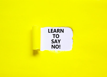 Learn to say no symbol. Concept words phrase Learn to say no on beautiful white paper. Beautiful yellow paper background. Business motivational psychological Learn to say no concept. Copy space.の写真素材