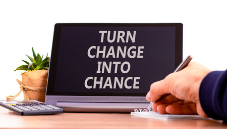 Turn change into chance symbol. Concept words phrase Turn change into chance on beautiful tablet. Businessman's hand. Beautiful white background. Business Turn change into chance concept. Copy space.の写真素材
