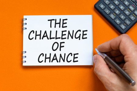 The challenge of chance symbol. Concept words phrase The challenge of chance on beautiful white note. Calculator. Beautiful orange background. Business The challenge of chance concept. Copy space.の写真素材
