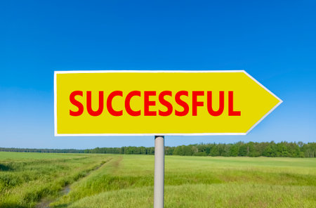 Successful symbol. Concept word Successful on beautiful yellow road sign. Beautiful blue sky green grass and forest peaceful nature background. Business successful concept. Copy space.の写真素材