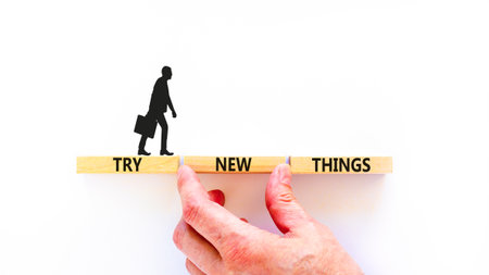 Try new things symbol. Concept words Try new things on beautiful wooden block. Businessman's hand. Beautiful white background. Business motivational lifestyle try new things concept. Copy space.の写真素材