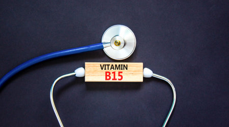 Vitamin B15 pantothenic acid symbol. Concept words Vitamin B15 on beautiful wooden block. Stethoscope. Beautiful black background. Medical healthy lifestyle Vitamin B15 concept.の写真素材