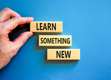 Learn something new symbol. Concept words Learn something new on beautiful block. Businessman's hand. Beautiful blue background Business motivational lifestyle learn something new concept Copy spaceの写真素材