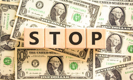 Stop symbol. Concept word Stop on beautiful wooden blocks. Dollar bills. Beautiful background from dollar bills. Business, lifestyle, support and stop concept. Copy space.の写真素材
