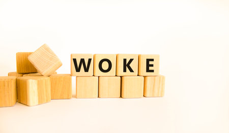 Woke question symbol. Concept word Woke question on beautiful wooden blocks. Beautiful white table white background. Business, lifestyle, support and raised question concept. Copy space.の写真素材