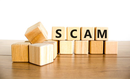 Scam symbol. Concept word Scam on beautiful wooden blocks. Beautiful wooden table white background. Business, lifestyle, support and scam concept. Copy space.の写真素材