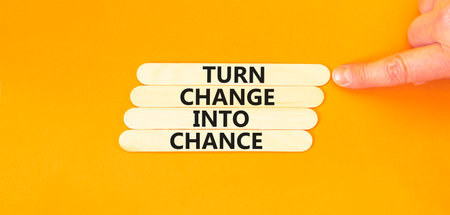 Turn change into chance symbol. Concept words phrase Turn change into chance on beautiful wooden stick. Beautiful orange paper background. Business Turn change into chance concept. Copy space.の写真素材