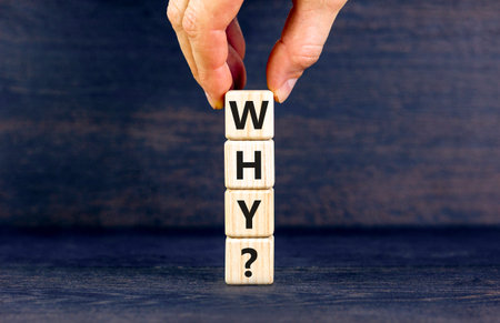 Why question symbol. Concept word Why question on beautiful wooden blocks. Businessman hand. Beautiful black table black background. Business, lifestyle, support and why question concept. Copy space.の写真素材