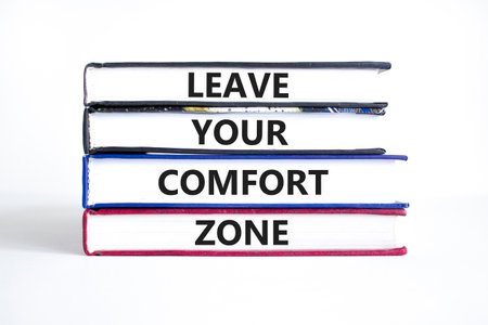 Leave your comfort zone symbol. Concept words Leave your comfort zone on beautiful books. Beautiful white paper background. Business psychological Leave your comfort zone concept. Copy space.の写真素材