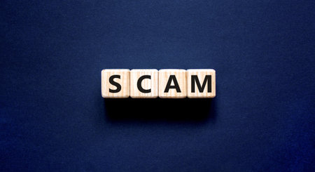 Scam symbol. Concept word Scam on beautiful wooden blocks. Beautiful black table black background. Business, lifestyle, support and scam concept. Copy space.の写真素材