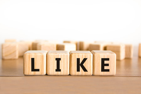 Like symbol. Concept word Like on beautiful wooden blocks. Beautiful wooden table white background. Business, lifestyle, support and like concept. Copy space.の写真素材
