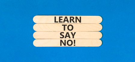 Learn to say no symbol. Concept words phrase Learn to say no on beautiful wooden stick. Beautiful blue paper background. Business psychological Learn to say no concept. Copy space.の写真素材