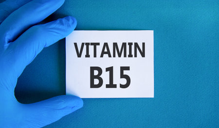 Vitamin B15 pantothenic acid symbol. Concept words Vitamin B15 on beautiful white card. Doctor's hand in blue medical glove. Beautiful blue background. Medical healthy lifestyle Vitamin B15 concept.の写真素材