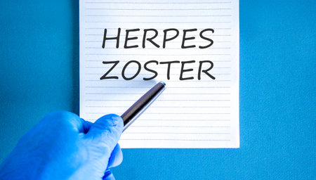Herpes zoster symbol. Concept words Herpes zoster on beautiful white note. Doctor's hand in blue...