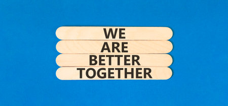 We are better together symbol. Concept words phrase We are better together on beautiful wooden stick. Beautiful blue paper background. Business We are better together concept. Copy space.の写真素材