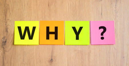 Why question symbol. Concept word Why question on beautiful colored paper. Beautiful wooden table...