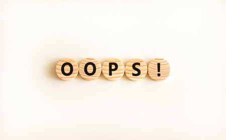 Oops symbol. Concept word Oops on beautiful wooden circles. Beautiful white table white background....