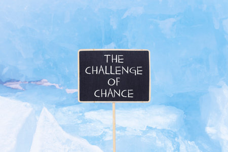 The challenge of chance symbol. Concept words phrase The challenge of chance on beautiful black blackboard. Beautiful blue ice background. Business The challenge of chance concept. Copy space.の写真素材