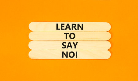 Learn to say no symbol. Concept words phrase Learn to say no on beautiful wooden stick. Beautiful orange paper background. Business psychological Learn to say no concept. Copy space.の写真素材