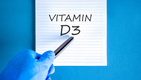 Vitamin D3 symbol. Concept words Vitamin D3 on beautiful white note. Doctor's hand in blue medical glove. Black pen. Beautiful blue background. Medical healthy lifestyle Vitamin D3 concept.の写真素材
